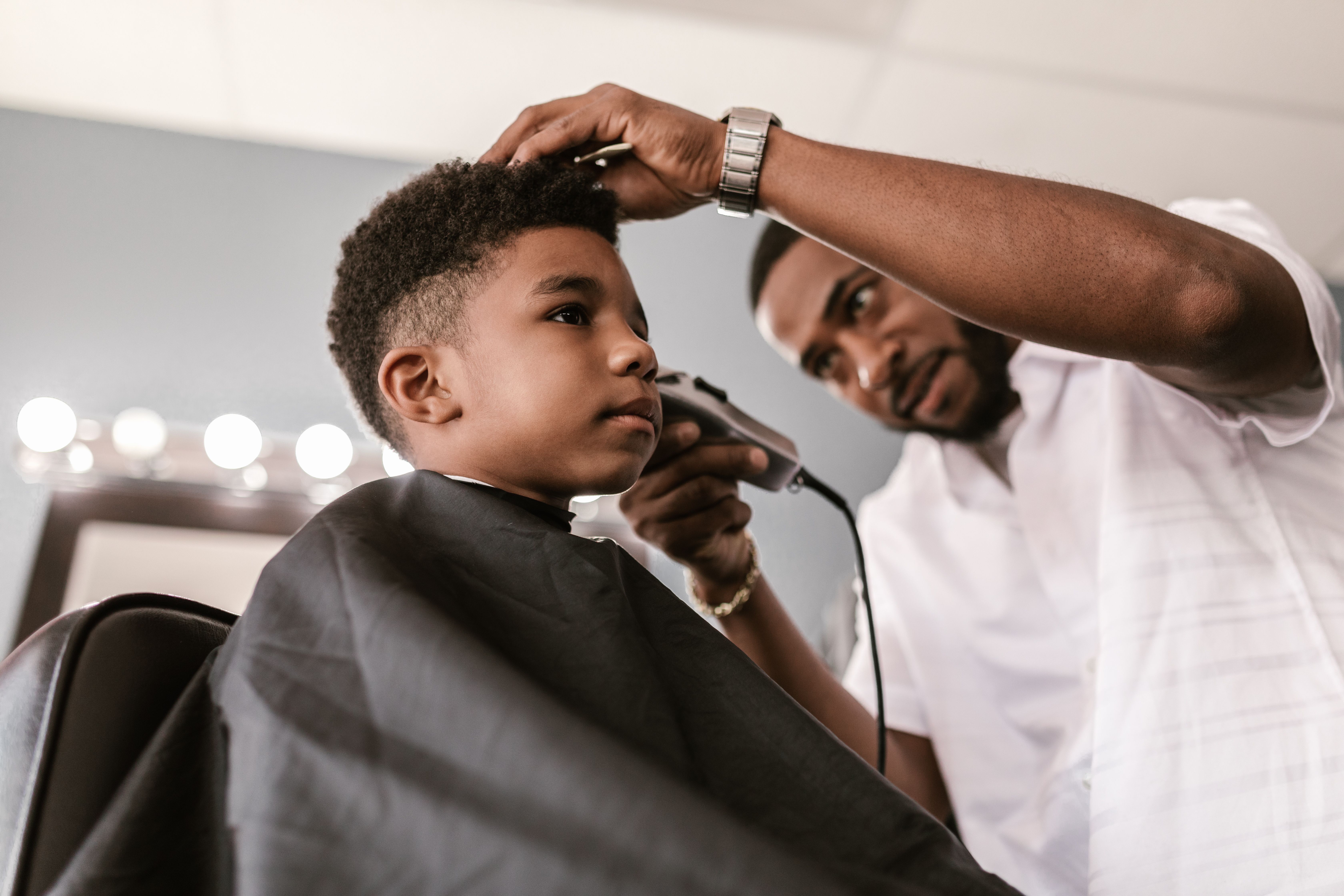 Barber giving a young client a fresh cut at Trims in Thornton Heath